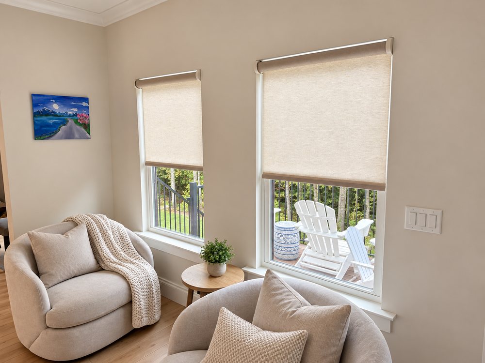Sitting room with motorized Lutron roller shades lowered partway over two windows